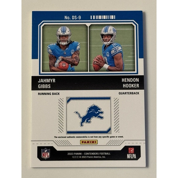 2023 Panini Contenders rookie ticket card featuring Jahmyr Gibbs and Hendon Hooker with Detroit Lions memorabilia swatches