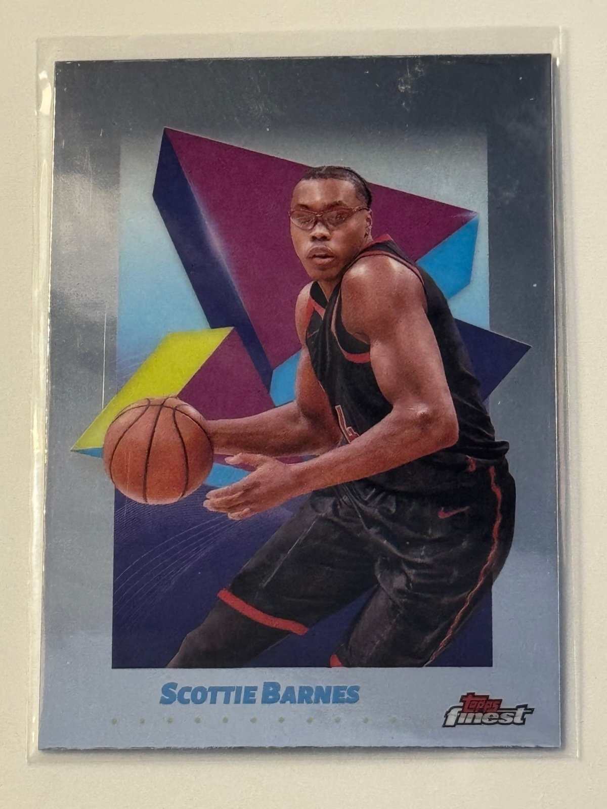 Scottie Barnes 2025 Topps Finest NBA Toronto Raptors basketball trading card with vibrant geometric background.