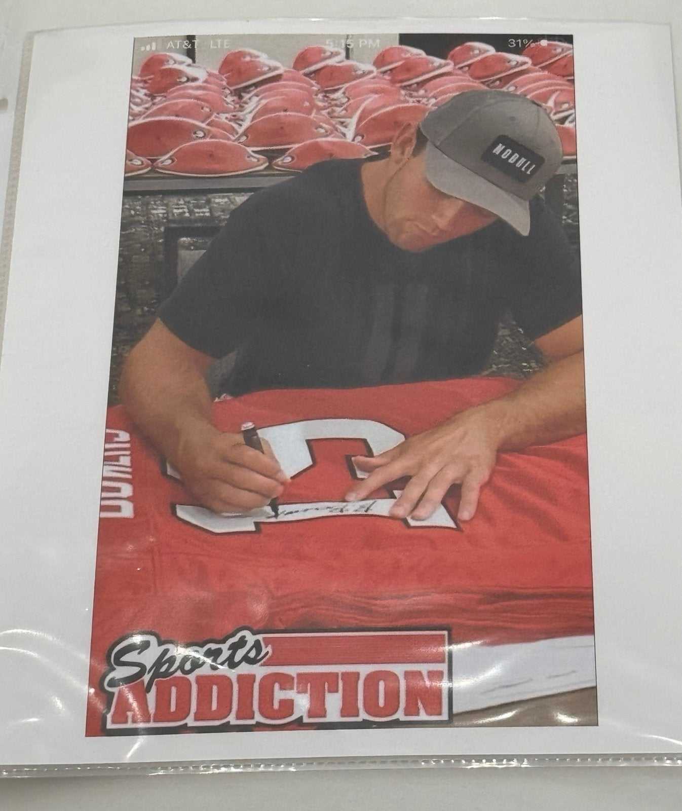 Brock Bowers signing Georgia Bulldogs black jersey with Sports Addiction logo